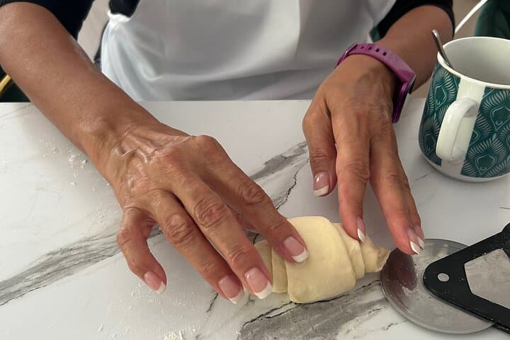 A student rolling a croissant