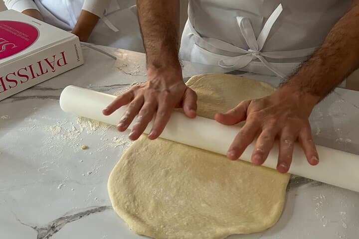 A student rolling the dough