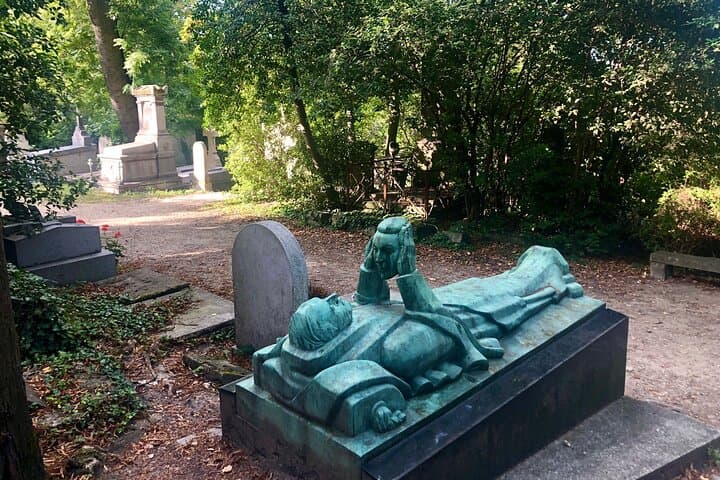 The grave of Fernand Arbelot, on which features a bronze sculpture of a man lying down and gazing into a woman’s disembodied face held aloft in his hands - a sign of love and adoration