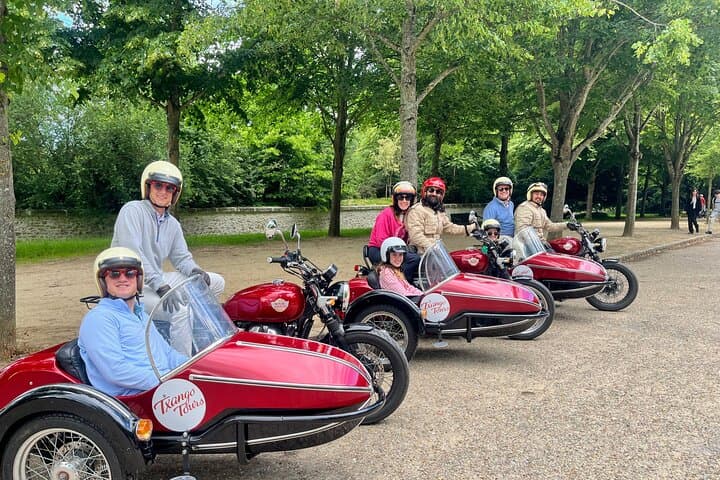 A family explores the Versailles grounds by sidecar