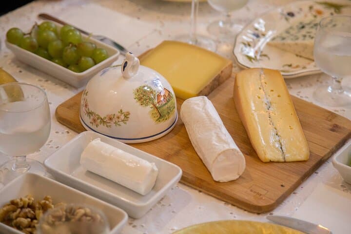 curated variety of farm cheeses, each bursting with unique character, perfectly paired with crusty, warm baguette