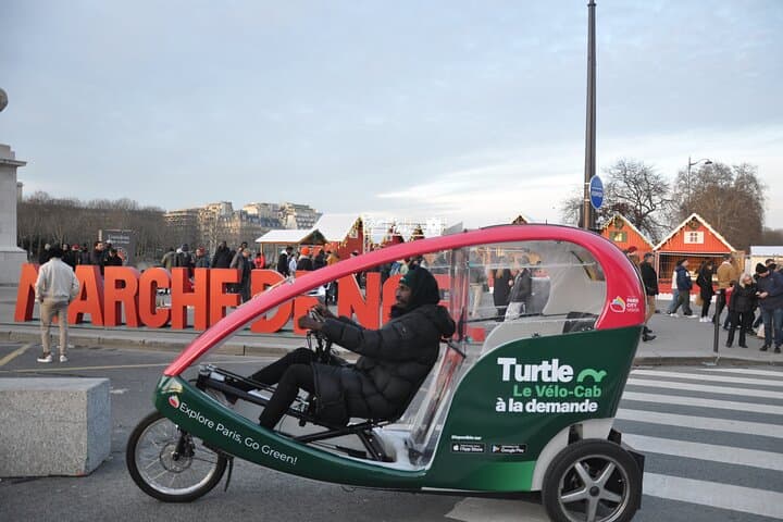 Paris visits Christmas lights on board a cab bike