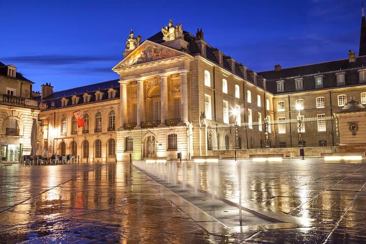 Palace of the Dukes of Burgundy: The majestic Liberation Square illuminated at night.