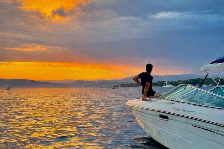 “Private boat at anchor during sunset cruise”