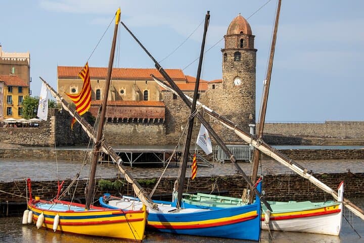 Notre-Dame-des-Anges: The iconic bell tower and the traditional Catalan boats on Boramar beach.