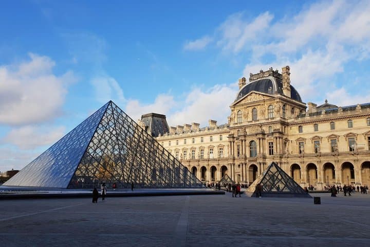 Louvre Museum and its iconic glass pyramid, Paris.