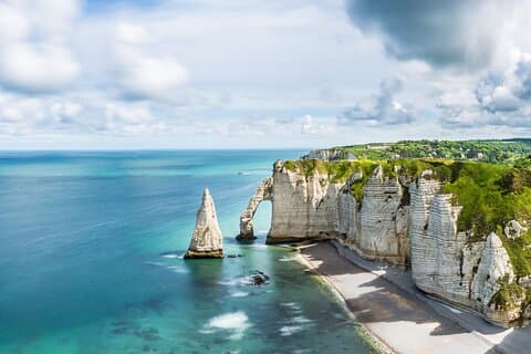 The Cliffs of Étretat are the town’s most iconic attraction, known for their stunning white chalk formations.