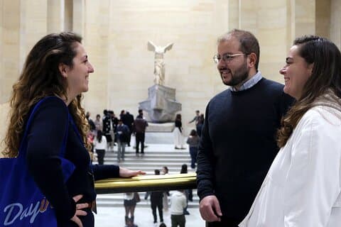 People having fun in front of the Victory of Samothrace