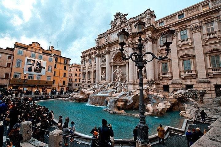 Visit rome and toss a coin in the Trevi fountain in Italy