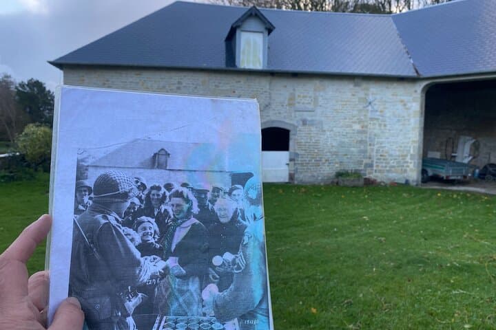 Hiesville, where a paratrooper of the 101st Airborne Division is giving C-rations to the locals.