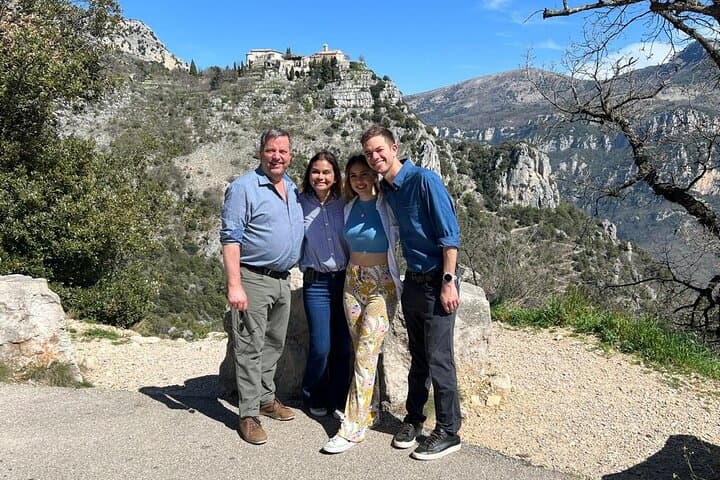 behind this beautiful family the small medieval village of Gourdon