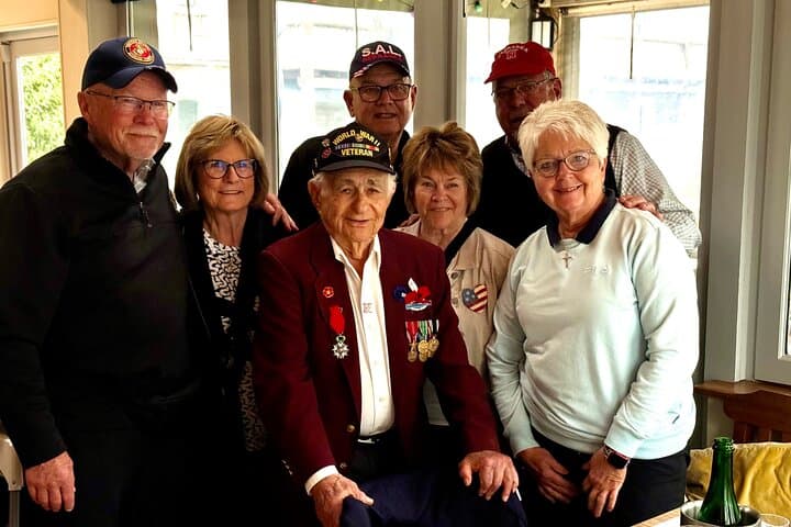 WWII veteran shares stories over lunch on Omaha Beach.