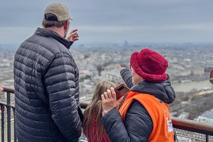 Our guide showing Paris on top of the Eiffel Tower