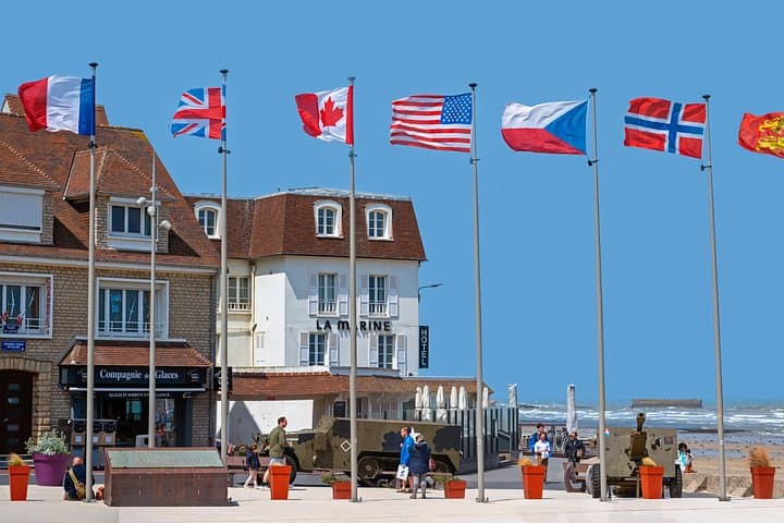 Flags of all nations involved at the D-Day waving in the wind in the village of Arromanches le Bains at the Normandy, France